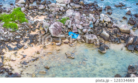 July 5 2025 Coastal Beach with Clear Water and Rock Formations in Natural Setting 128334669