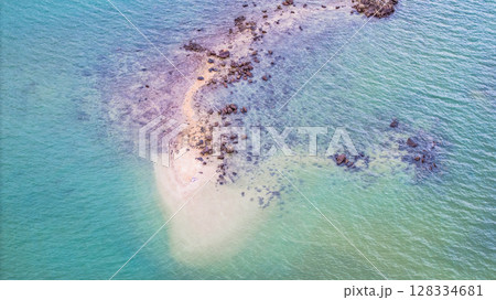 July 5 2025 Coastal Beach with Clear Water and Rock Formations in Natural Setting 128334681