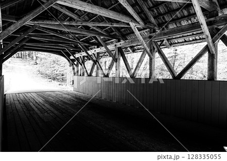 Flume Covered Bridge in New Hampshire's Franconia Notch State Park spanning the Pemigewasset River. Flume Covered Bridge in New Hampshire's Franconia Notch State Park spanning the Pemigewasset River. 128335055