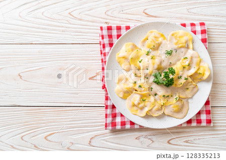 ravioli pasta with mushroom cream sauce and cheese 128335213