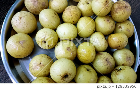 Fresh Amla or Indian Gooseberry in Steel Plate Fresh Amla or Indian Gooseberry in Steel Plate 128335956