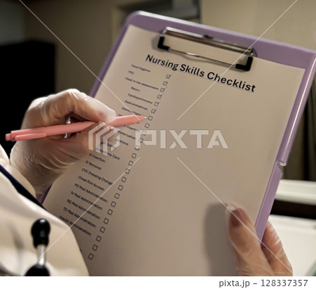 Nurse Completing Clinical Skills Checklist with Gloved Hands 128337357