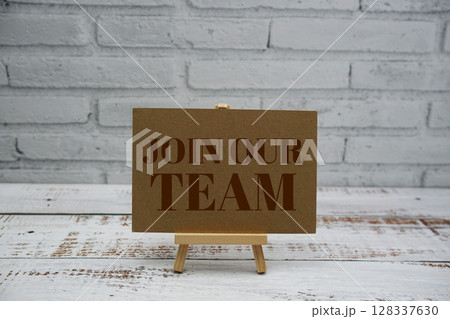 Join Our Team text message with easel stand on wooden background 128337630