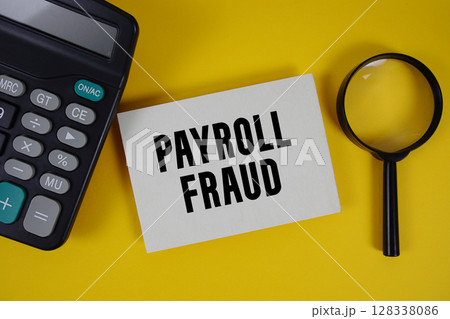 Payroll Fraud text with magnifying glass anc calculator on yellow background 128338086