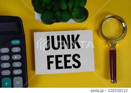 Junk fees text with magnifying glass anc calculator on yellow background Junk fees text with magnifying glass anc calculator on yellow background 128338112