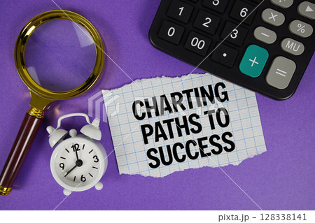 Charting Paths To Success text with alarm clock, magnifying glass anc calculator on purple background 128338141
