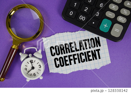 Correlation Coefficient text with alarm clock, magnifying glass anc calculator on purple background 128338142