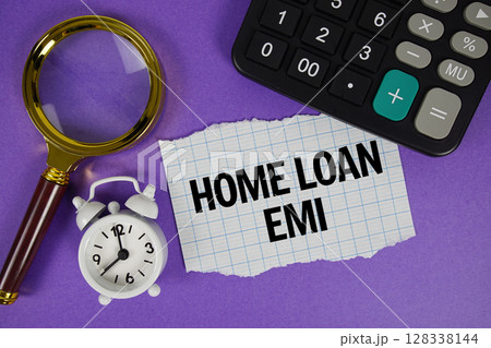Home Loan EMI text with alarm clock, magnifying glass anc calculator on purple background 128338144