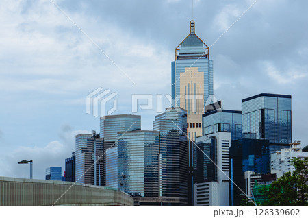 Tall buildings and cloudy sky in a city 128339602