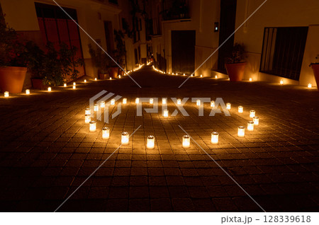 Enchanting Night Scene of Candlelit Pathway in Village Street 128339618