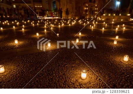 Peaceful Night Scene Illuminated by Candles in an Outdoor Setting 128339621