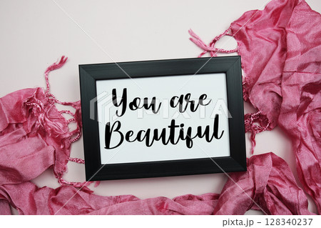 You are Beautiful Motivational and Inspirational quotes on light pink background 128340237