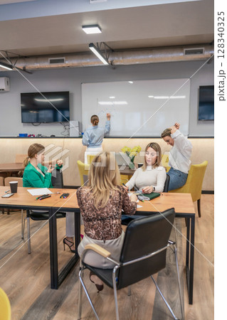 Meeting brainstorming whiteboard office women planning business charts ideas today. Meeting brainstorming whiteboard office women planning business charts ideas today. 128340325