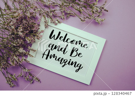 Welcome and Be Amazing text with flowers bouquet decoration on purple background Welcome and Be Amazing text with flowers bouquet decoration on purple background 128340467