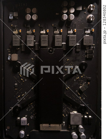 Electronic circuit board with processor and metal components, showing old computer technology in close-up 128340802