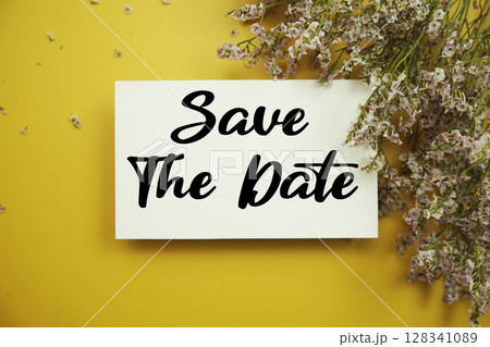 Save The Date text with flowers decoration on yellow background 128341089