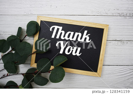 Thank You text with artificial green leaf eucalyptus on blue background 128341159