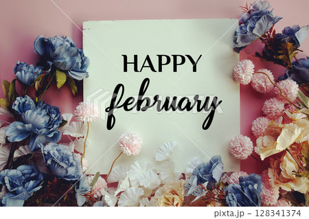 Happy February text with flowers decorations on pink background 128341374
