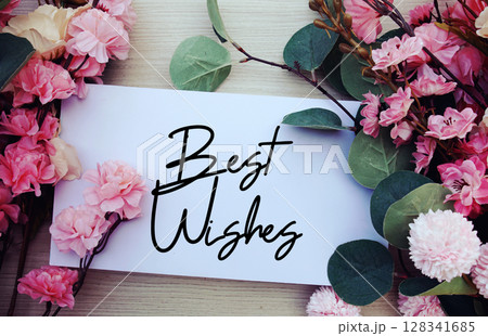 Best Wishes text with flowers decorations on wooden background 128341685