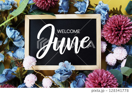 Welcome June text with flowers decoration on yellow background Welcome June text with flowers decoration on yellow background 128341778