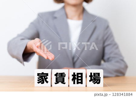 家賃相場のブロックとスーツを着たミドル女性ビジネスウーマン 家賃相場のブロックとスーツを着たミドル女性ビジネスウーマン 128341884