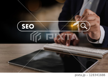 SEO search engine optimization Business person using digital device to search for SEO strategies with search bar overlay showing word SEO 128341886
