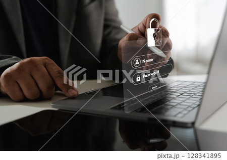 Cybersecurity Data privacy image shows person using laptop with digital overlay of login form and padlock icon, symbolizing cybersecurity Cybersecurity Data privacy image shows person using laptop with digital overlay of login form and padlock icon, symbolizing cybersecurity 128341895