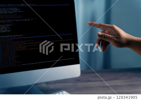 Programming code on representing person pointing computer screen displaying code, indicating programming or software development activity Programming code on representing person pointing computer screen displaying code, indicating programming or software development activity 128341905