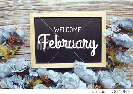 Welcome February text with flowers frame decoration top view on wooden background, Welcome February text with flowers frame decoration top view on wooden background, 128341968
