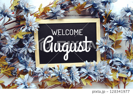 Welcome August text with flowers frame decoration top view on wooden background, Welcome August text with flowers frame decoration top view on wooden background, 128341977