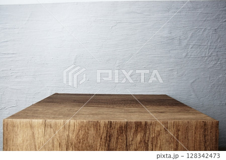 Empty wooden podium stand for display products front of concrete background Empty wooden podium stand for display products front of concrete background 128342473