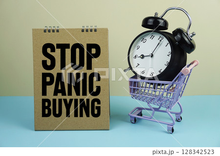 Stop Panic Buying wiht mini trolley shopping cart and alarm clock on blue and yellow background 128342523