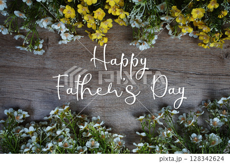 Happy Father's Day text message with flowers decoration on wooden background 128342624