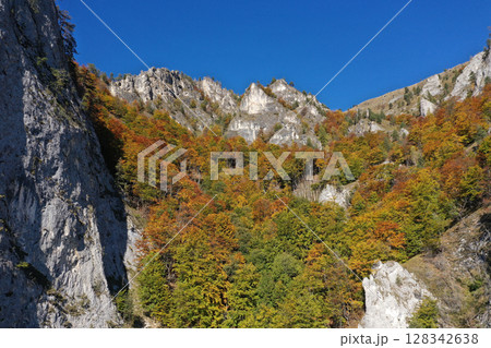 Aerial view of rocky limestone mountains and autumn forest 128342638