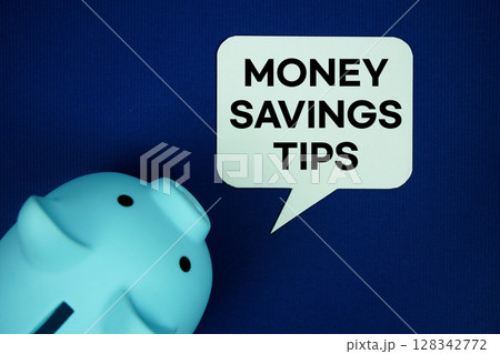 Money Savings Tips text on speech bubble with piggy bank top view on navy blue background Money Savings Tips text on speech bubble with piggy bank top view on navy blue background 128342772