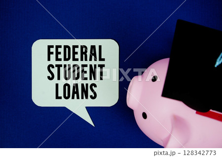 Federal Student Loans text on speech bubble with piggy bank and graduation cap top view on navy blue background 128342773