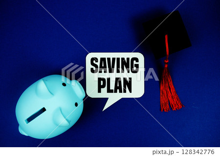 Saving Plan text on speech bubble with piggy bank and graduation cap top view on navy blue background Saving Plan text on speech bubble with piggy bank and graduation cap top view on navy blue background 128342776