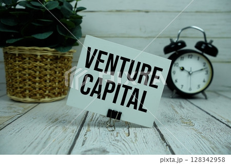 Venture Capital text on paper card with alarm clock on wooden background 128342958