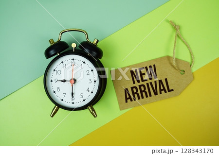 New Arrival text on price tag with alarm clock and trolley shopping cart on green, yellow geometric background New Arrival text on price tag with alarm clock and trolley shopping cart on green, yellow geometric background 128343170
