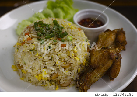 Fried Rice With Egg And Fried Chicken On Plate, Background for advertising and wallpaper in culture and food scene. Fried Rice With Egg And Fried Chicken On Plate, Background for advertising and wallpaper in culture and food scene. 128343180