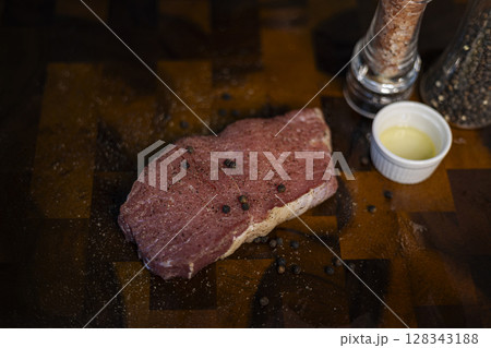 Fresh Raw Beef Steak With Rub On The Wood Board, Background for advertising and wallpaper in culture and food scene. 128343188