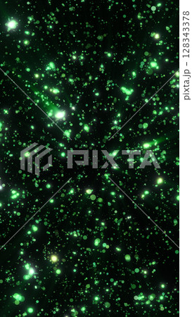 Green glowing bokeh particles scattered on a dark background, forming a radiant visual explosion of light points 128343378