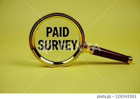 Paid Survey text with magnifying glass on yellow background 128343561