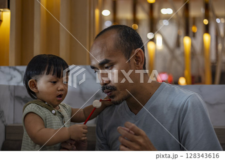 Father And Son Are Eating Hot Meatballs, Background for advertising and wallpaper in culture and food scene. 128343616