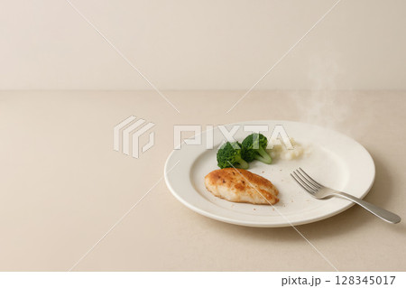 Homemade dinner with potatoes and vegetables on a light background. Space for text. 128345017