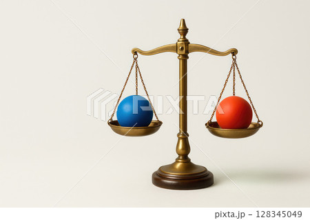 Colored balls lie on the bowls of the classic scales. Space for text. 128345049