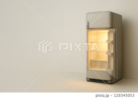 An antique refrigerator glows with a warm light from the inside. Space for text. An antique refrigerator glows with a warm light from the inside. Space for text. 128345053