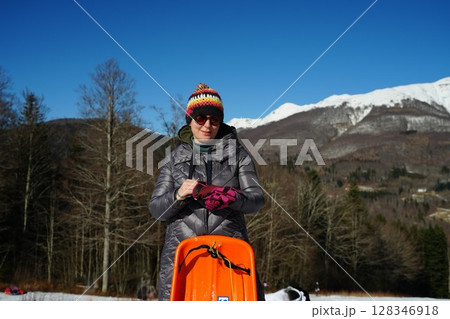 Preparing for Sledding on a Winter Day 128346918