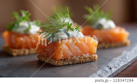 Candied salmon garnished with fresh herbs served on crisp crackers, showcasing a delightful appetizer presentation for gourmet dining experiences 128347284