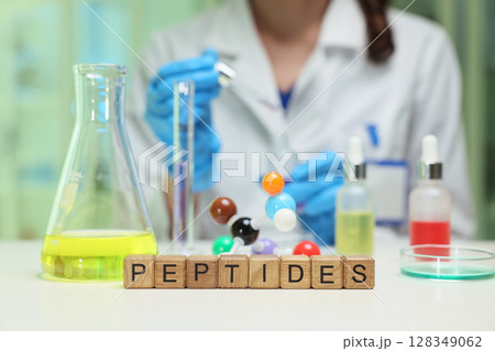 A vibrant laboratory scene featuring various peptides and specialized chemical analysis equipment A vibrant laboratory scene featuring various peptides and specialized chemical analysis equipment 128349062